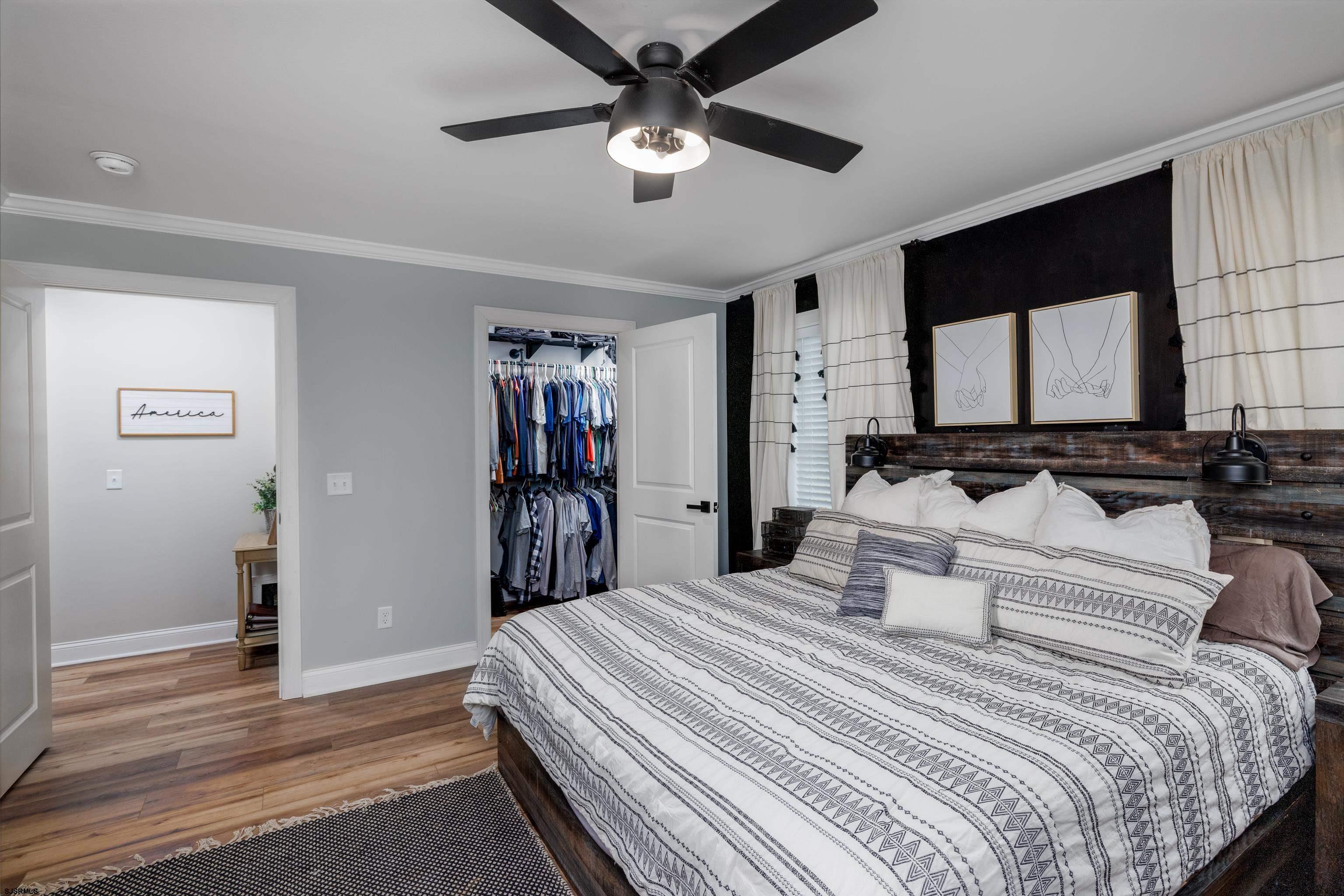 8 Gibson Lane Rio Grande, NJ 08210 - Photo 22 of 45 a bedroom with a bed and a chandelier