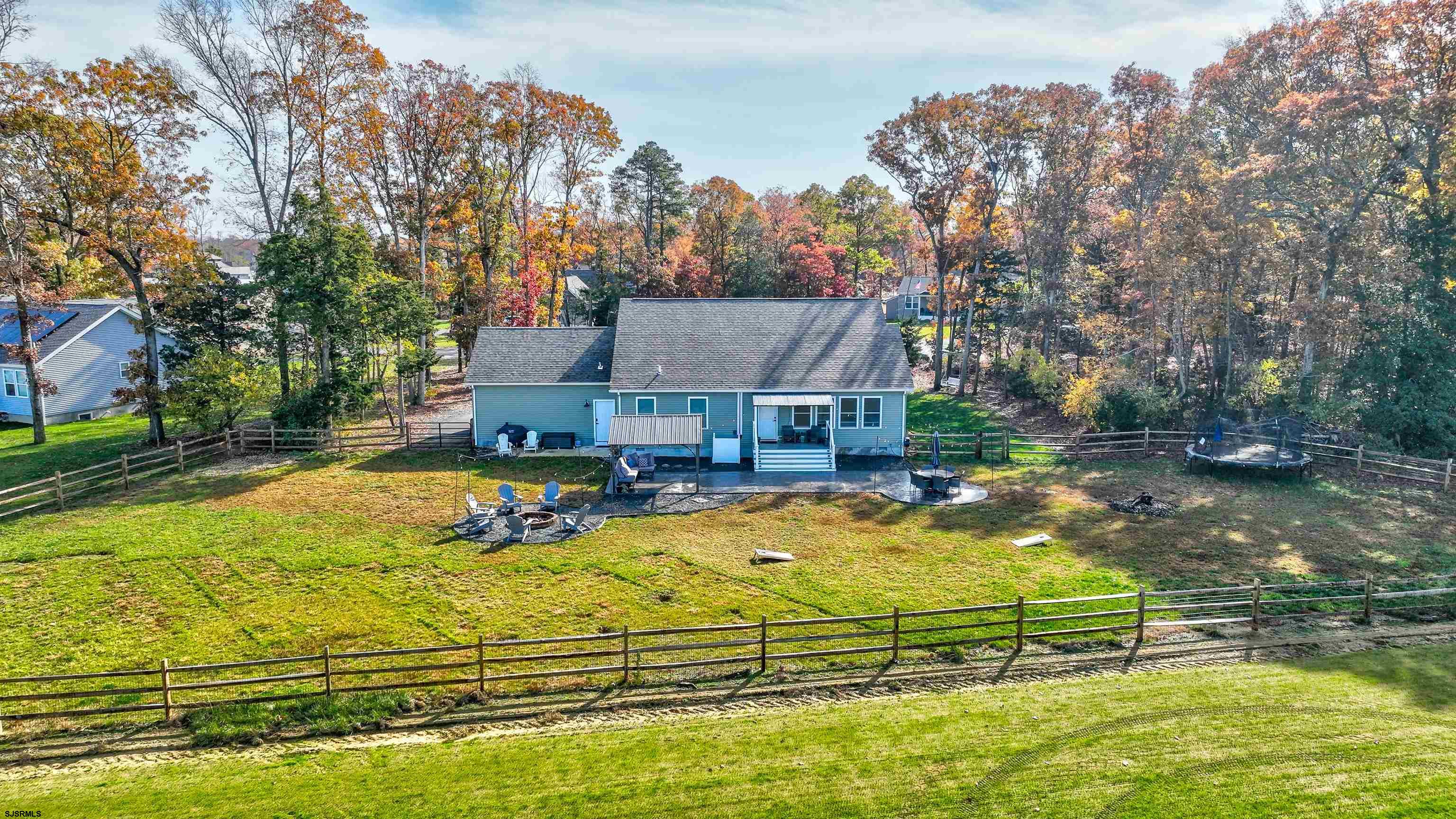 8 Gibson Lane Rio Grande, NJ 08210 - Photo 36 of 45 an aerial view of a house with swimming pool lawn chairs and a fire pit