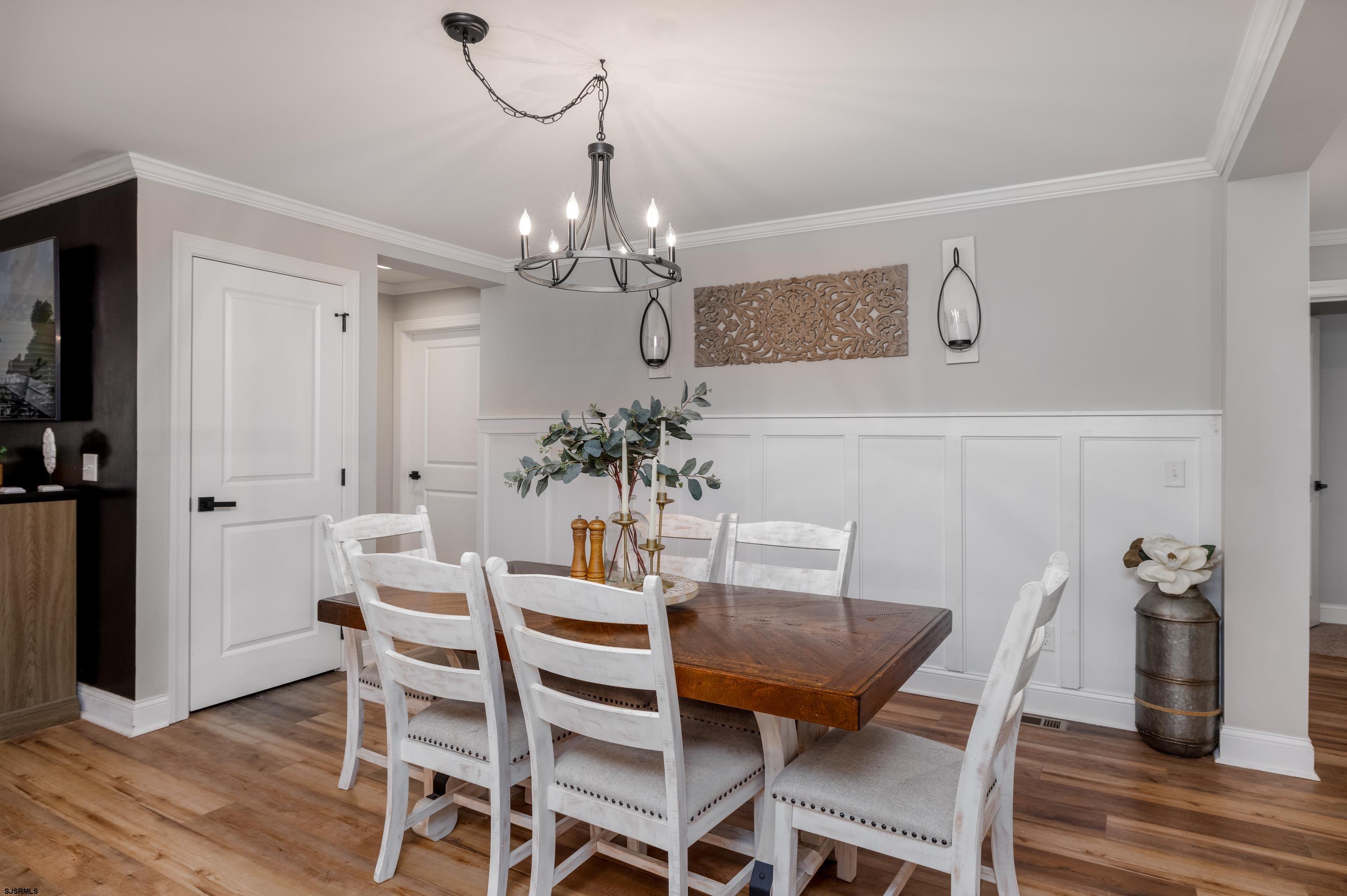 8 Gibson Lane Rio Grande, NJ 08210 - Photo 5 of 45 a view of a dining room with furniture wooden floor and chandelier
