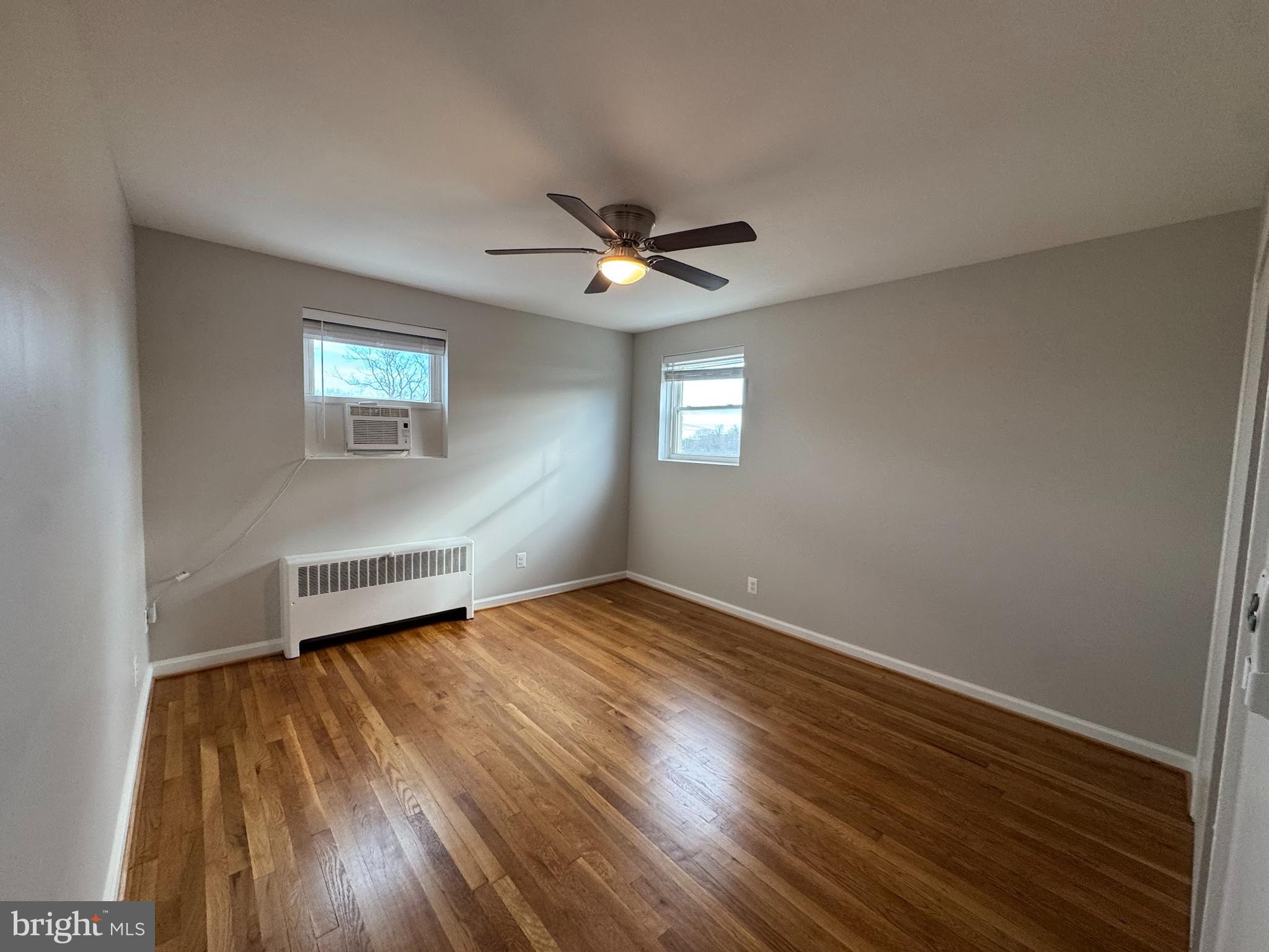 500 South Courthouse Road, Unit 12 Arlington, VA 22204 - Photo 13 of 21 a view of an empty room with a window and wooden floor