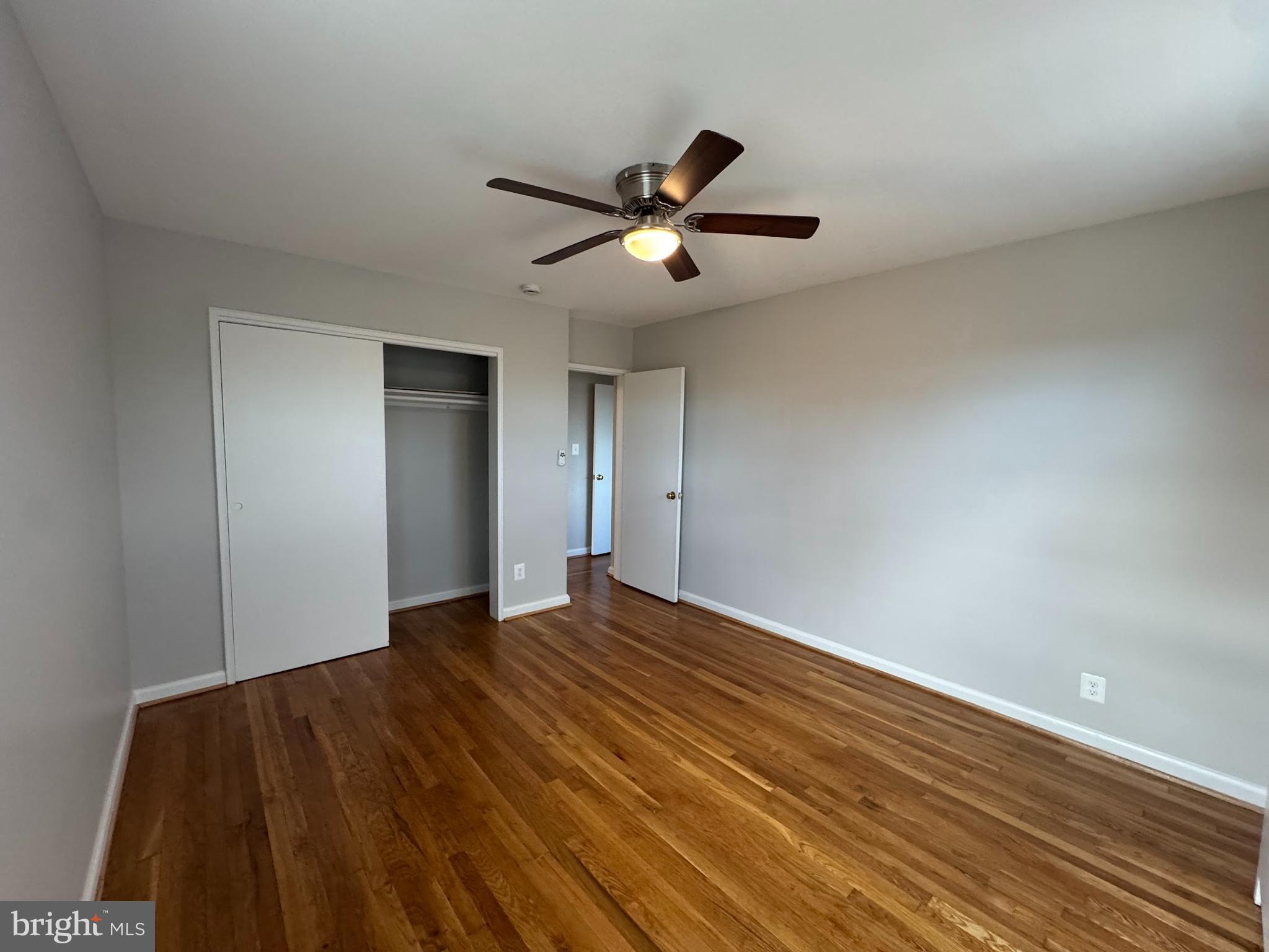 500 South Courthouse Road, Unit 12 Arlington, VA 22204 - Photo 14 of 21 a view of a big room with wooden floor and a ceiling fan