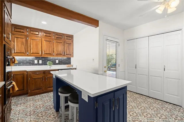 a kitchen with a sink cabinets and wooden floor