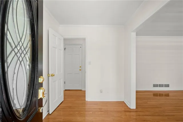 a view of a kitchen from a corridor