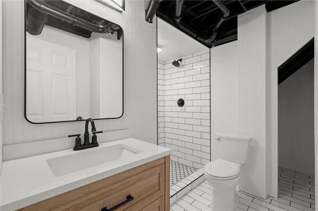 a bathroom with a sink a toilet and shower