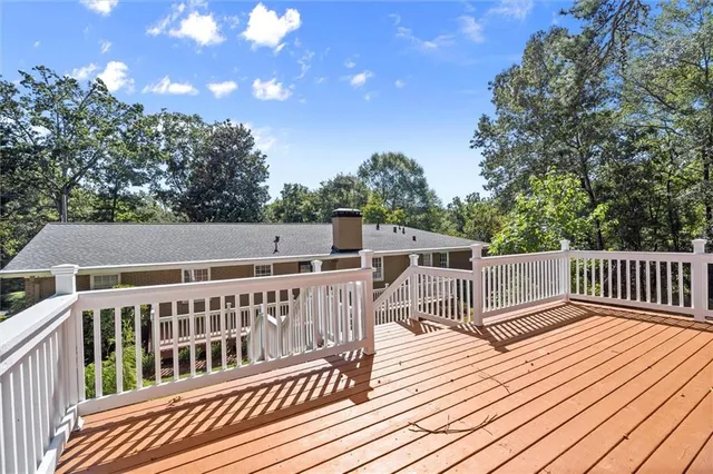 a view of balcony with deck and trees