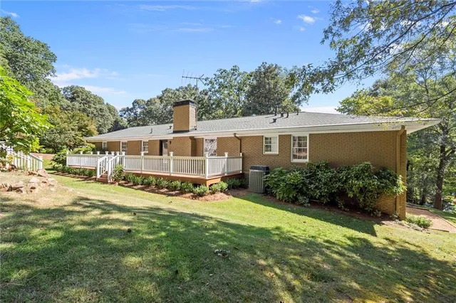 a view of a house with a big yard and potted plants