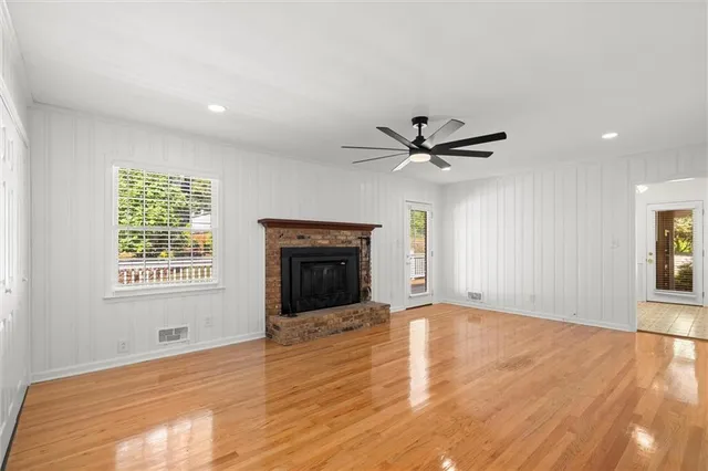 a view of an empty room with a window and a ceiling fan