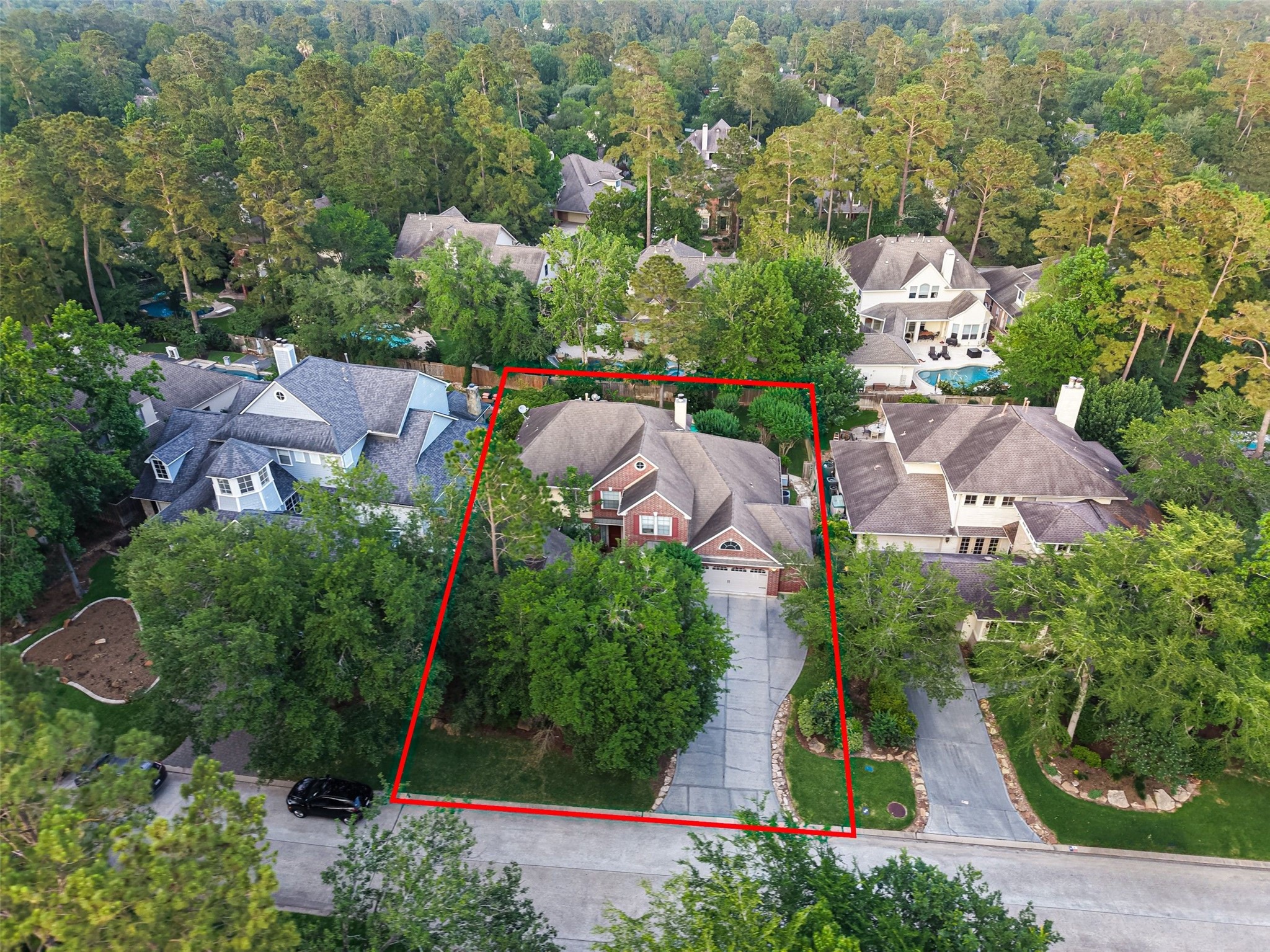 10 Mirror Ridge Drive The Woodlands, TX 77382 - Photo 47 of 48 Surrounded by mature trees, the home features a spacious oversized driveway with additional parking, including room for a third vehicle.