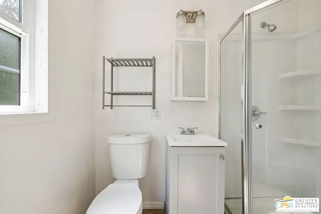 a white toilet sitting next to a bathroom sink