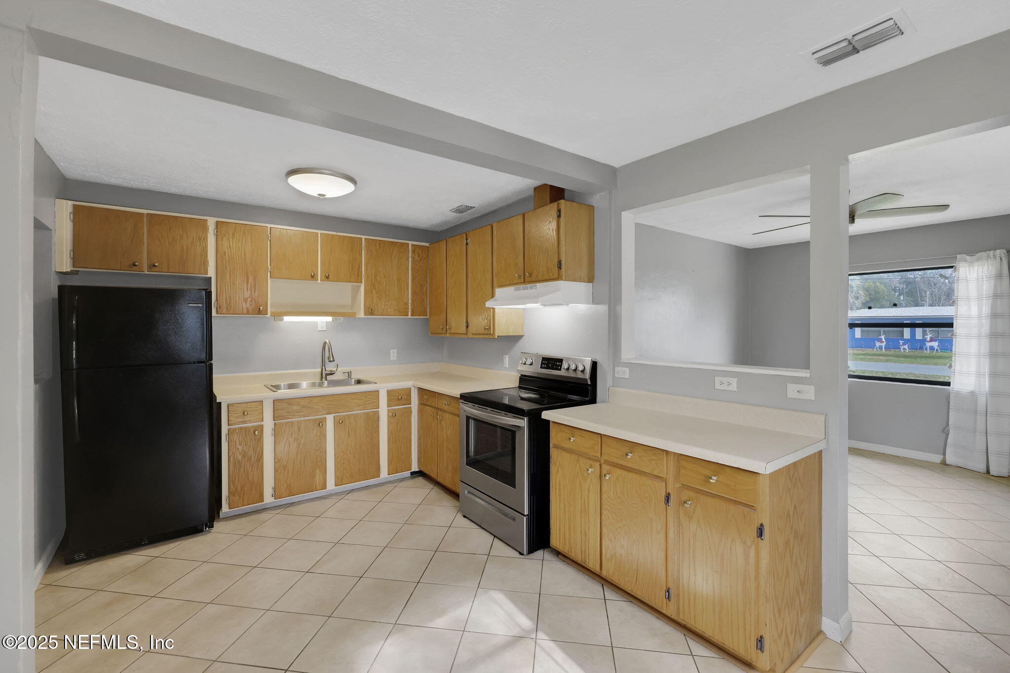 466 Aiken Road Jacksonville, FL 32216 - Photo 15 of 36 a kitchen with a stove sink and refrigerator