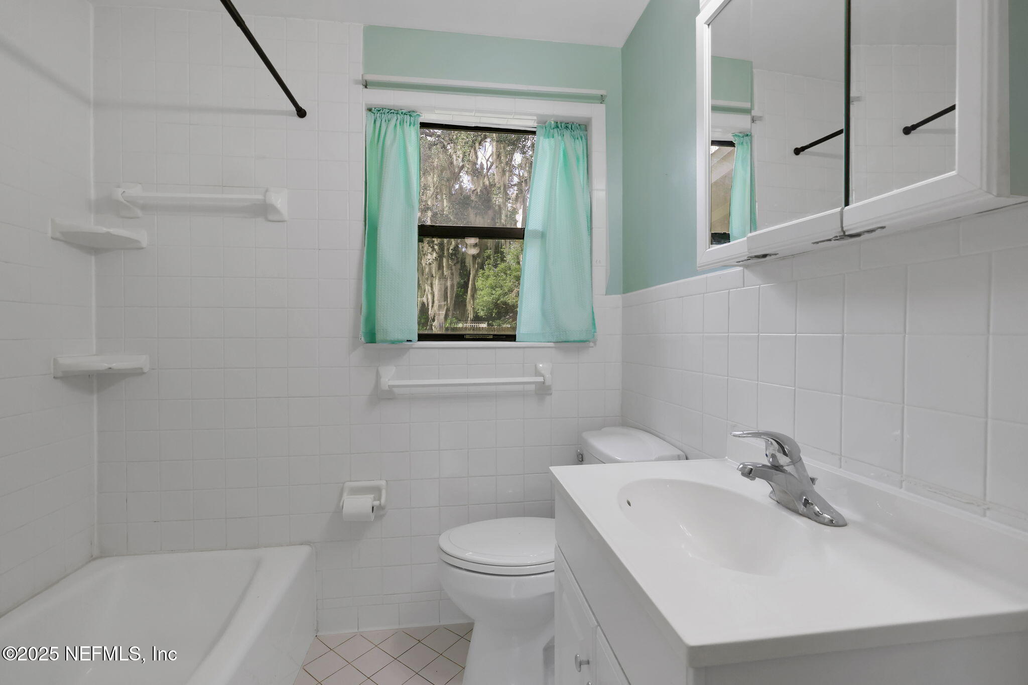466 Aiken Road Jacksonville, FL 32216 - Photo 22 of 36 a bathroom with a sink toilet and shower