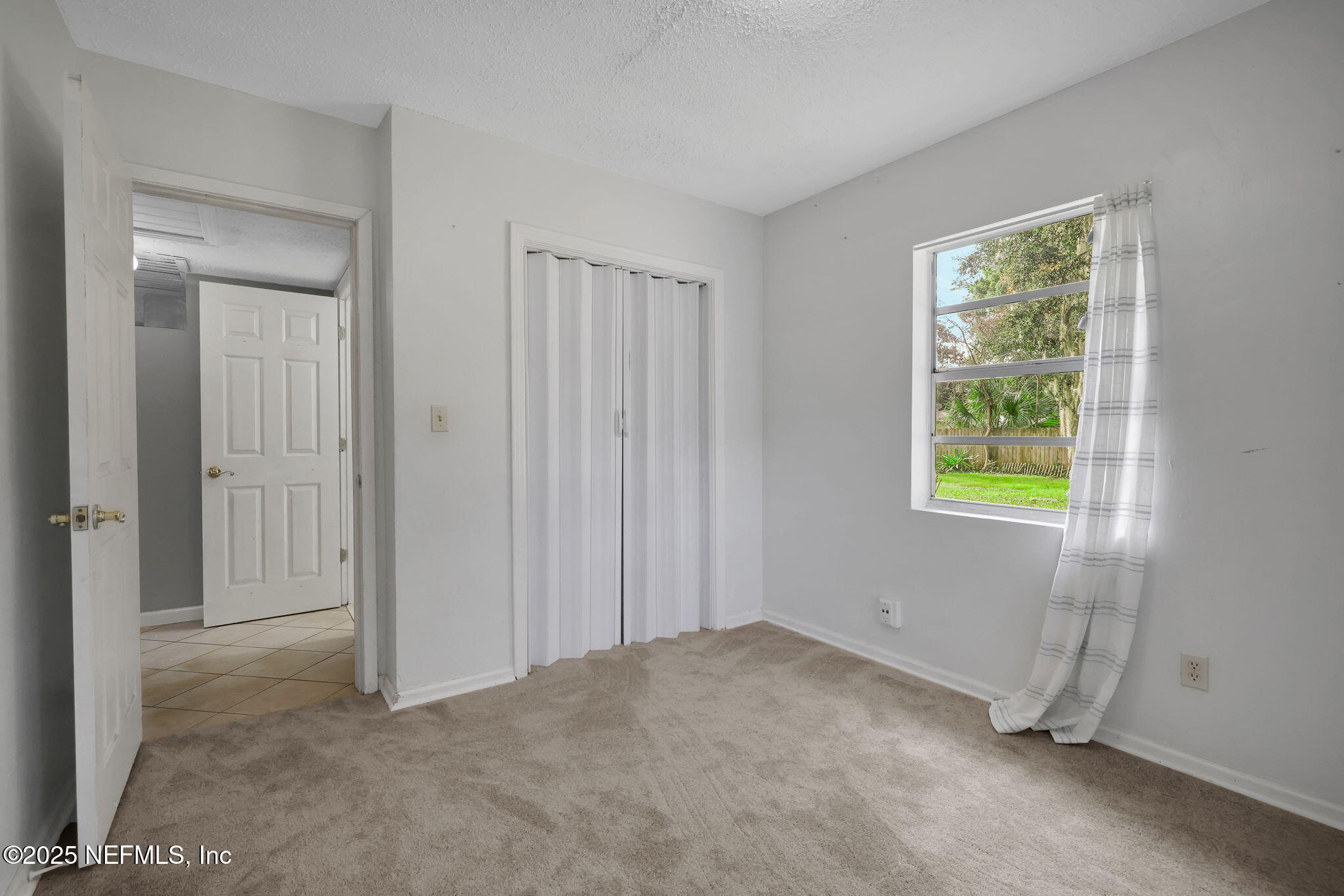 466 Aiken Road Jacksonville, FL 32216 - Photo 25 of 36 a view of a room that has a window in it