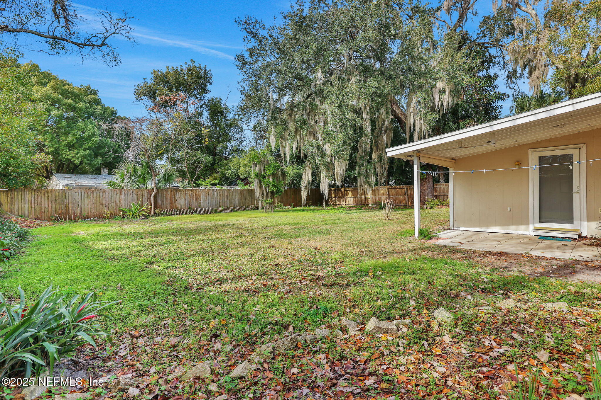 466 Aiken Road Jacksonville, FL 32216 - Photo 30 of 36 a view of a backyard with a garden and entertaining space