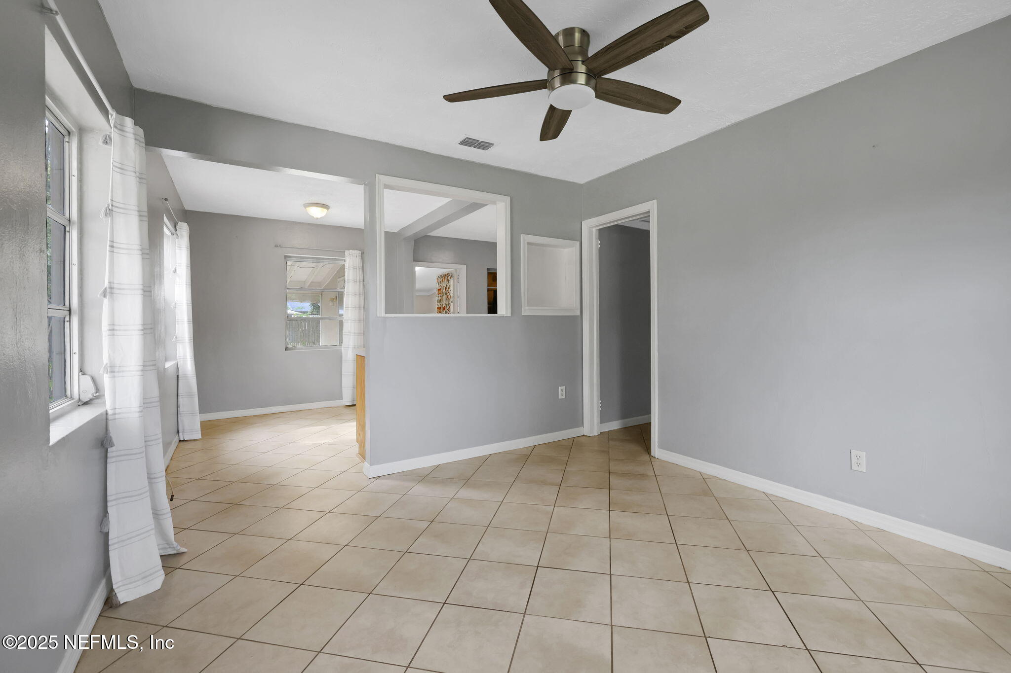 466 Aiken Road Jacksonville, FL 32216 - Photo 10 of 36 an empty room with fan and glass door