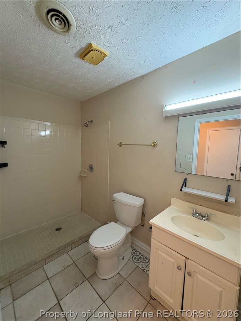 6324 Stoney Point Loop Fayetteville, NC 28306 - Photo 16 of 24 a bathroom with a sink a toilet and shower