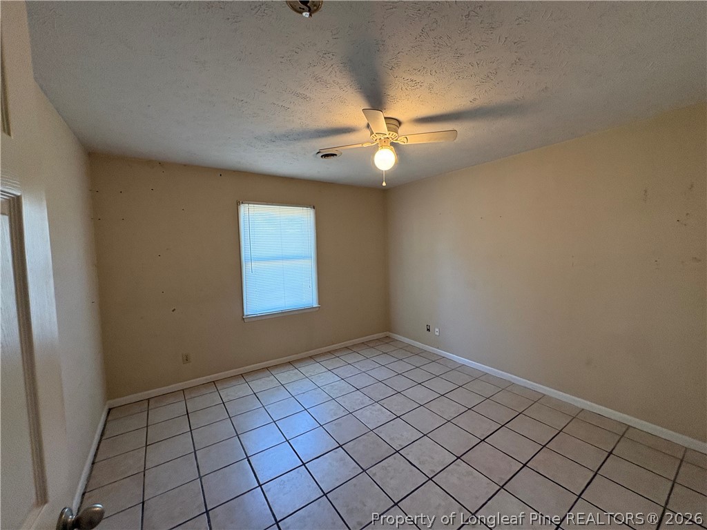 6324 Stoney Point Loop Fayetteville, NC 28306 - Photo 17 of 24 an empty room with windows and fan