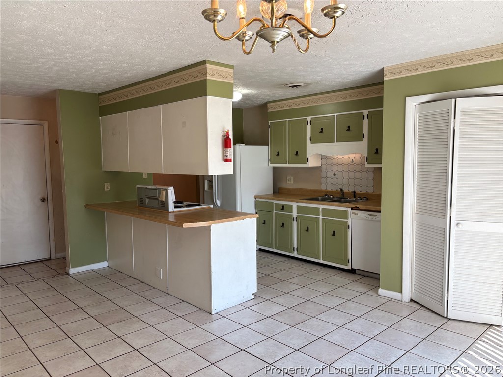 6324 Stoney Point Loop Fayetteville, NC 28306 - Photo 5 of 24 a kitchen with a sink cabinets and window