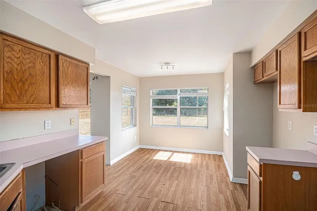 a view of a kitchen with wooden floor and a sink