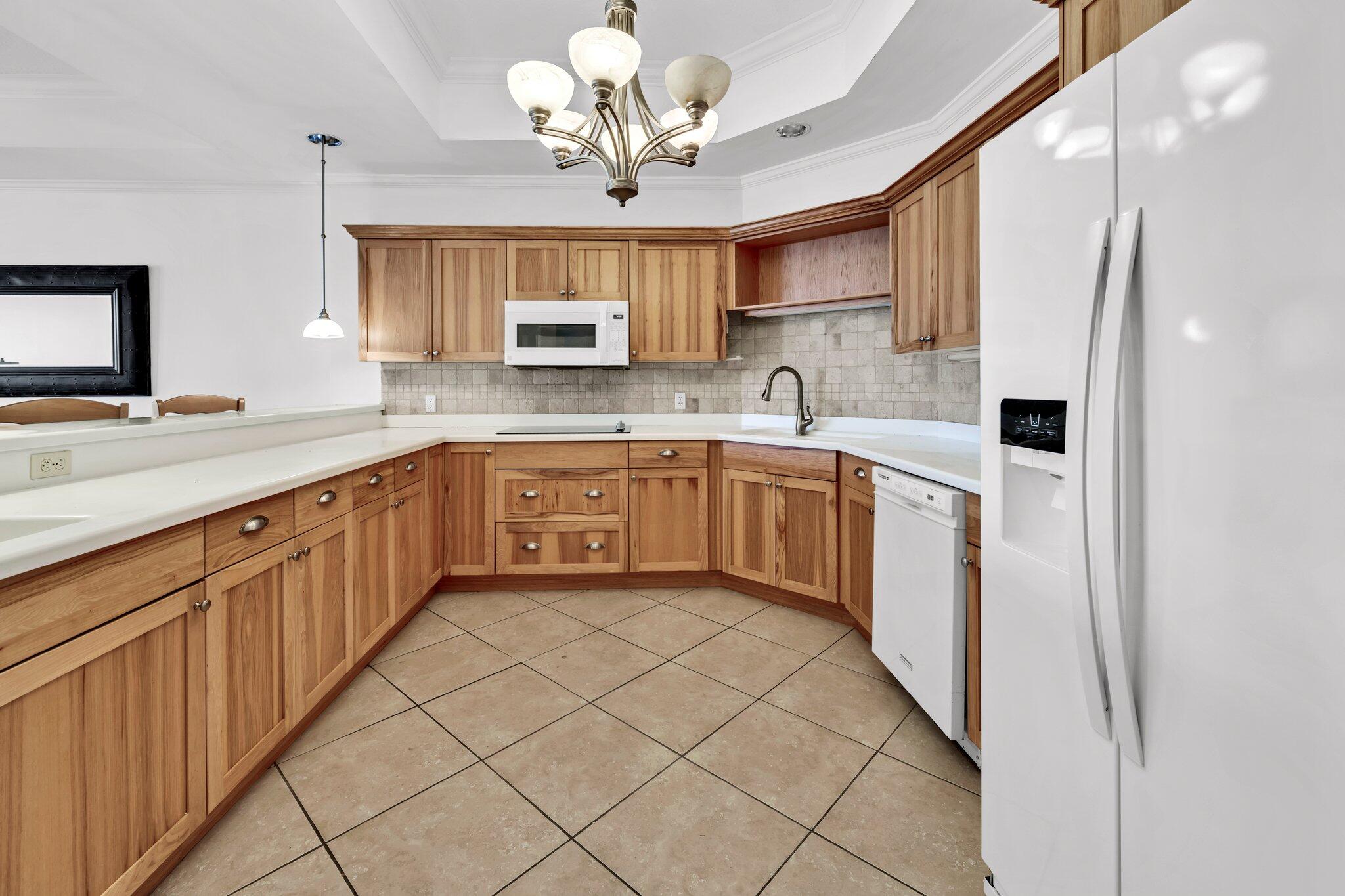 5 Calhoun Avenue, Unit 203 Destin, FL 32541 - Photo 14 of 67 a kitchen with a sink appliances and cabinets