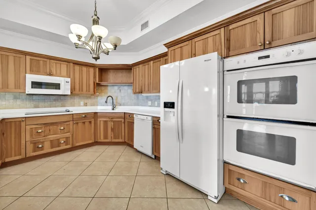 a living room with furniture and a dining table with rug