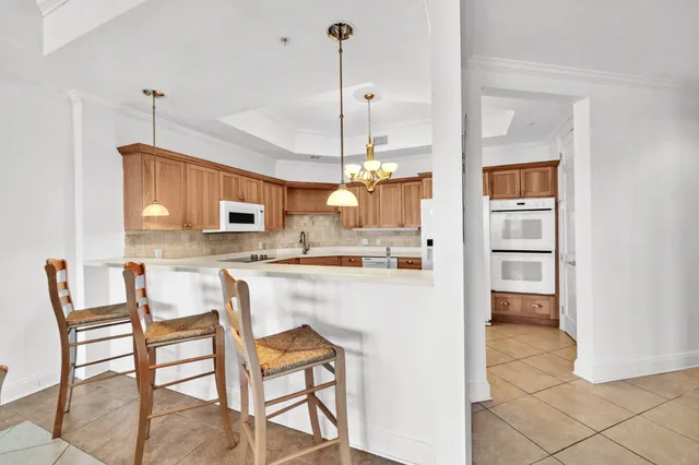 a view of a swimming pool and lounge chairs in back yard of the house