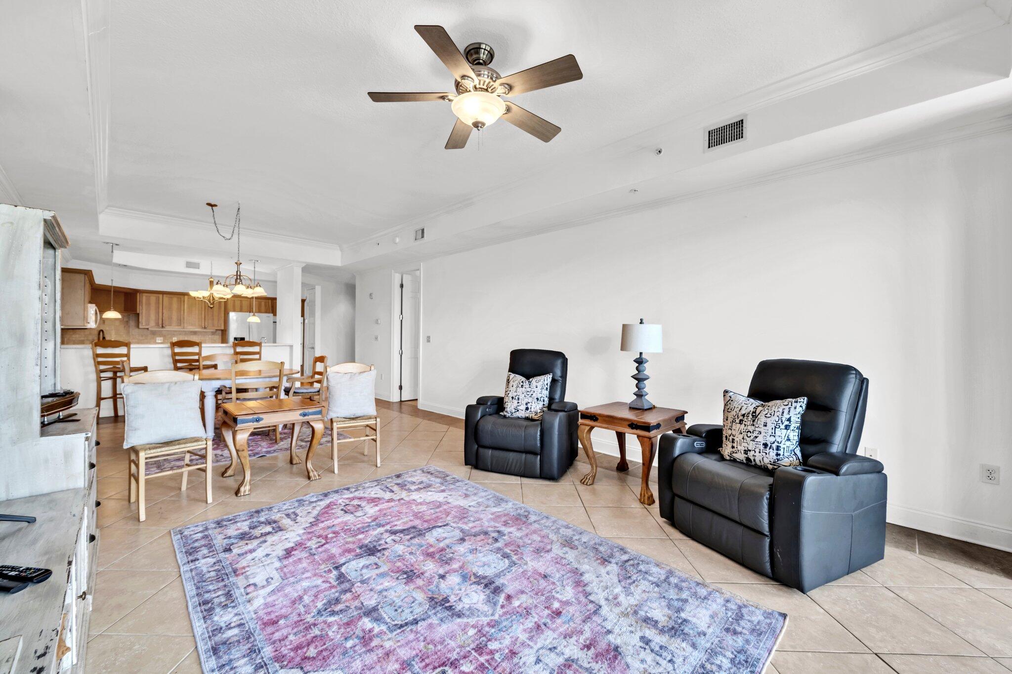 5 Calhoun Avenue, Unit 203 Destin, FL 32541 - Photo 20 of 67 a living room with furniture and a dining table with rug