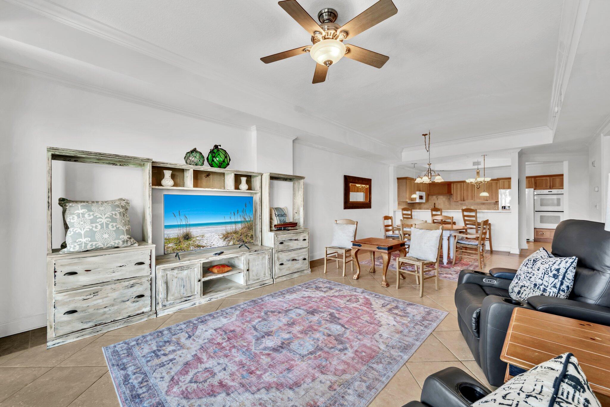 5 Calhoun Avenue, Unit 203 Destin, FL 32541 - Photo 21 of 67 a living room with furniture a rug and a flat screen tv