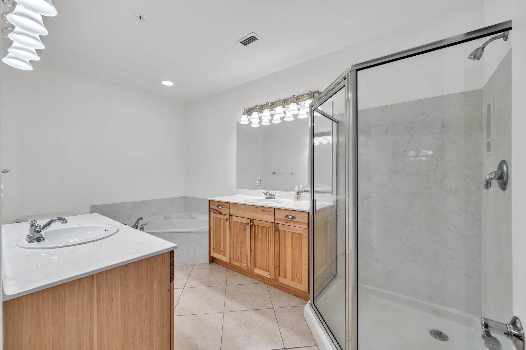 5 Calhoun Avenue, Unit 203 Destin, FL 32541 - Photo 30 of 67 a bathroom with a double vanity sink mirror and shower