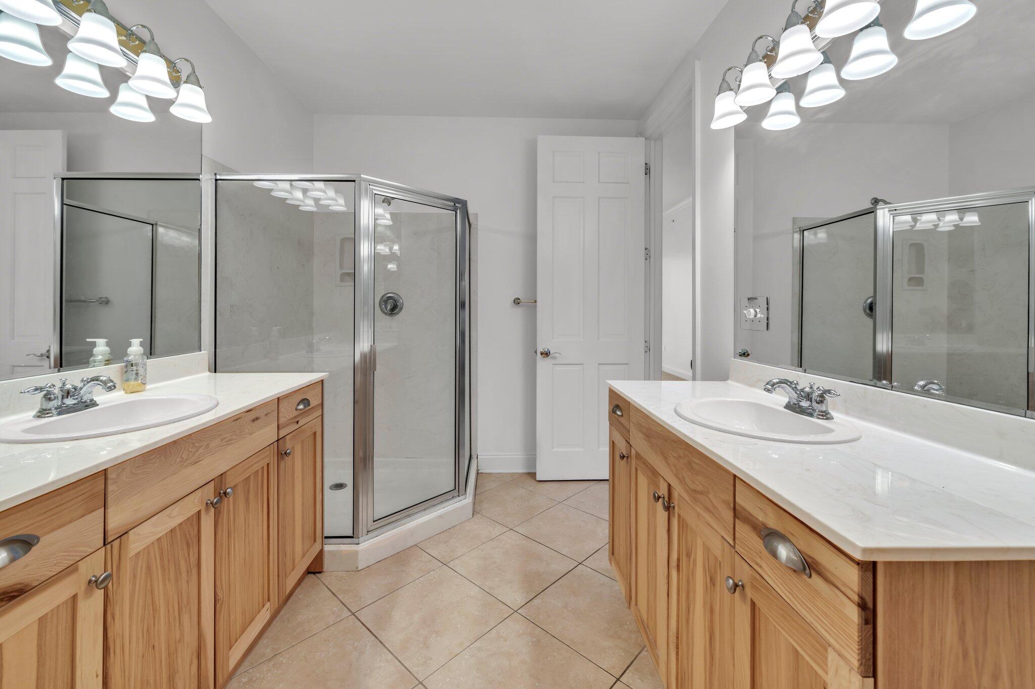 5 Calhoun Avenue, Unit 203 Destin, FL 32541 - Photo 31 of 67 a bathroom with a sink double vanity and a mirror