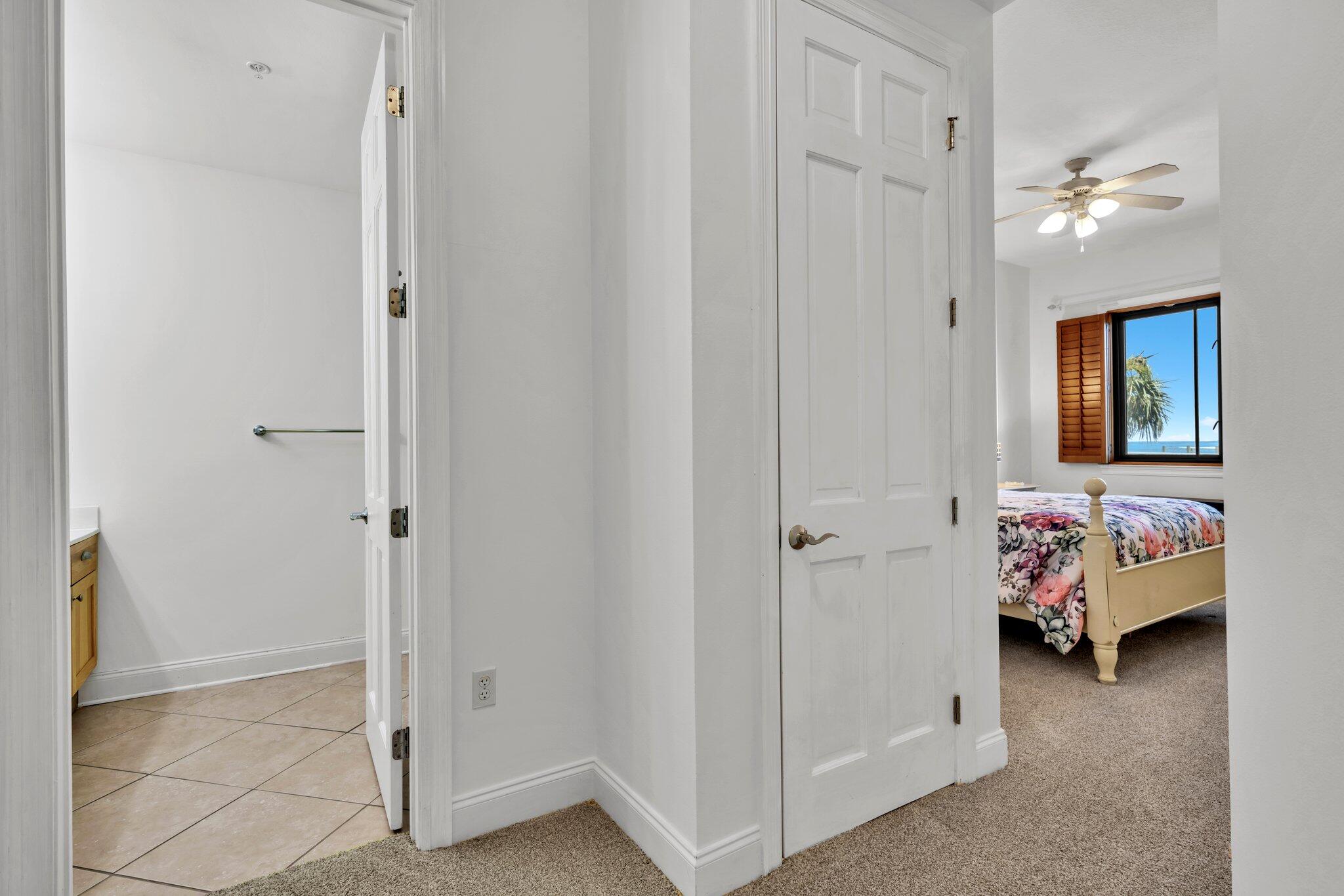 5 Calhoun Avenue, Unit 203 Destin, FL 32541 - Photo 33 of 67 a bedroom with a bed and a chandelier