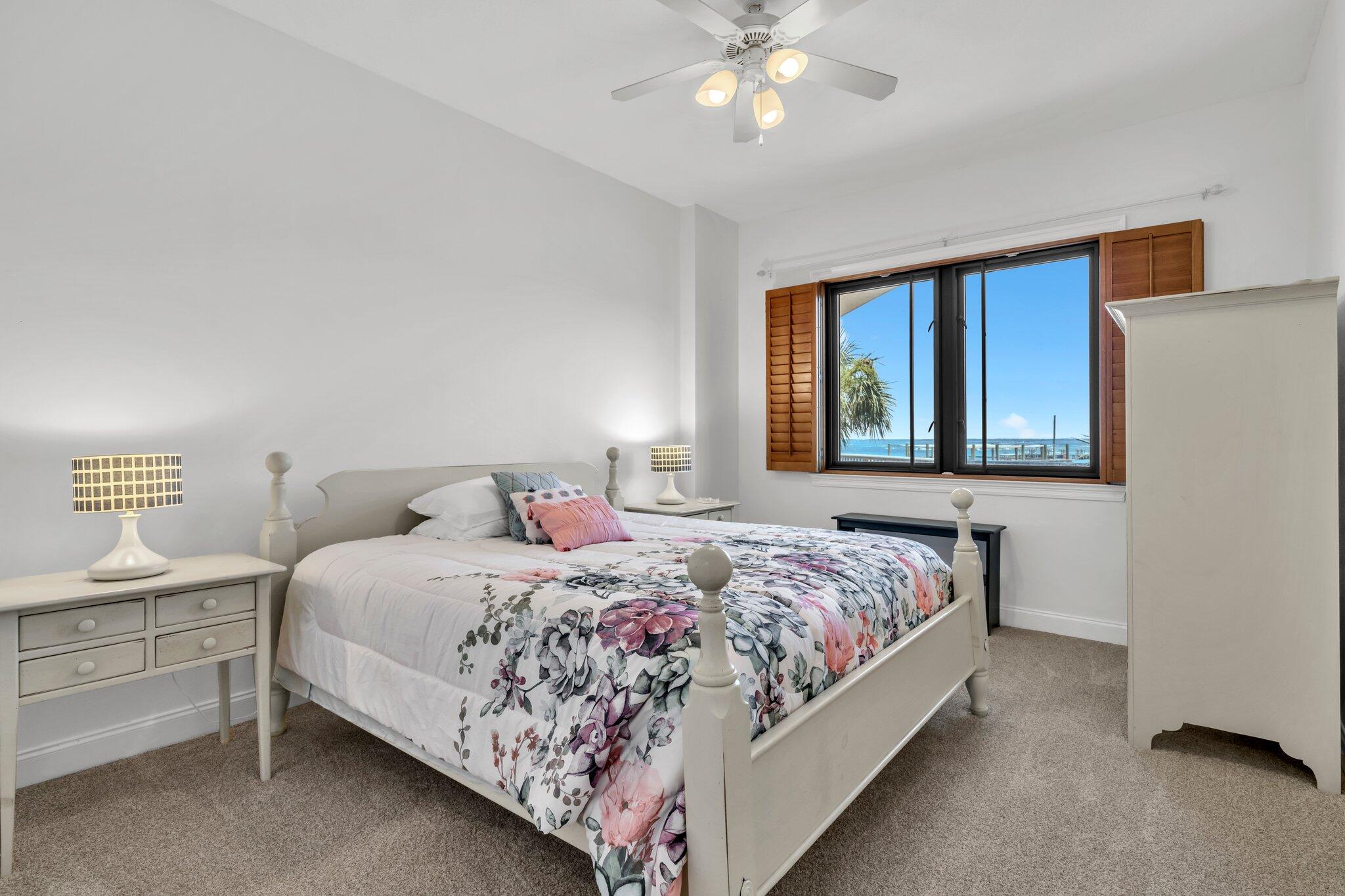 5 Calhoun Avenue, Unit 203 Destin, FL 32541 - Photo 34 of 67 a bedroom with a bed and a chandelier