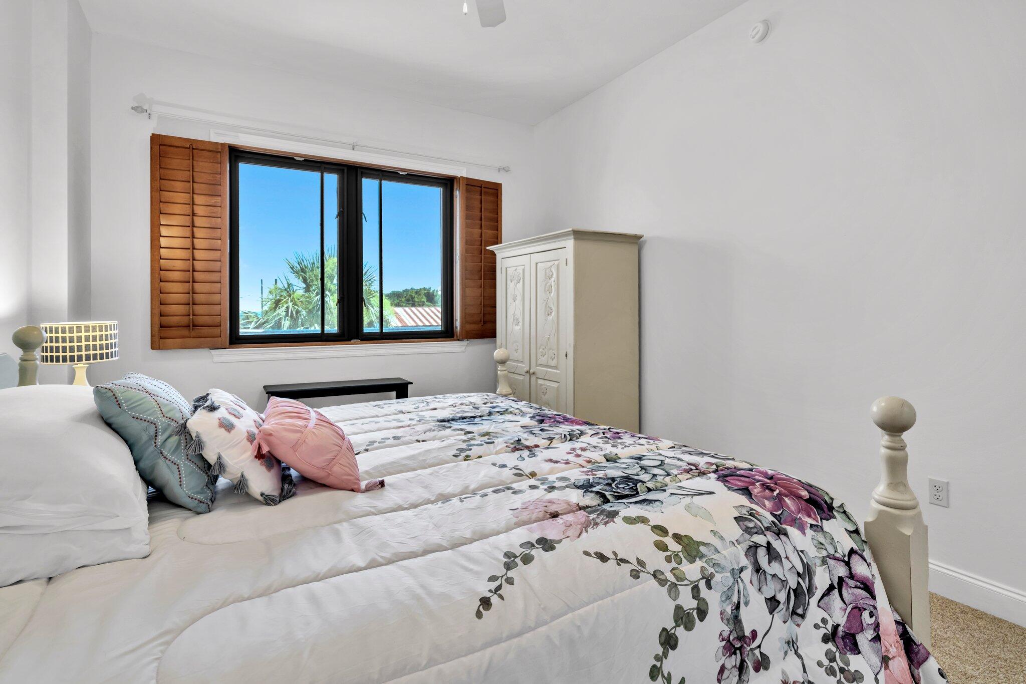 5 Calhoun Avenue, Unit 203 Destin, FL 32541 - Photo 35 of 67 a bedroom with a large bed and a window