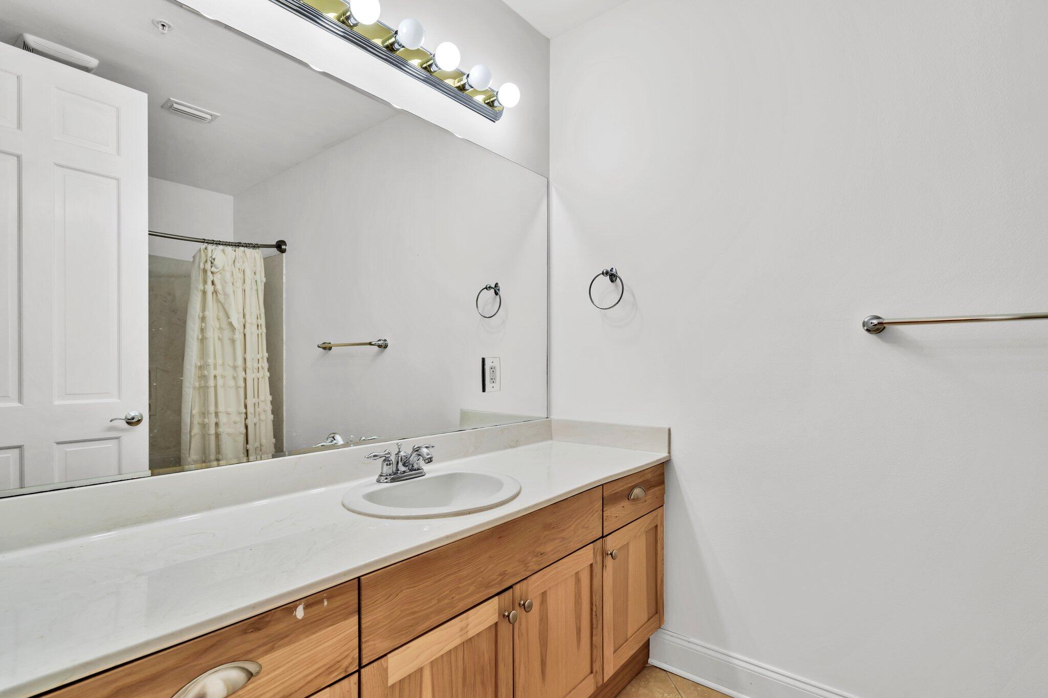 5 Calhoun Avenue, Unit 203 Destin, FL 32541 - Photo 36 of 67 a bathroom with a sink and a mirror