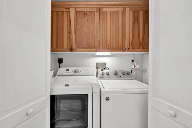 a view of a swimming pool with lawn chairs and a yard