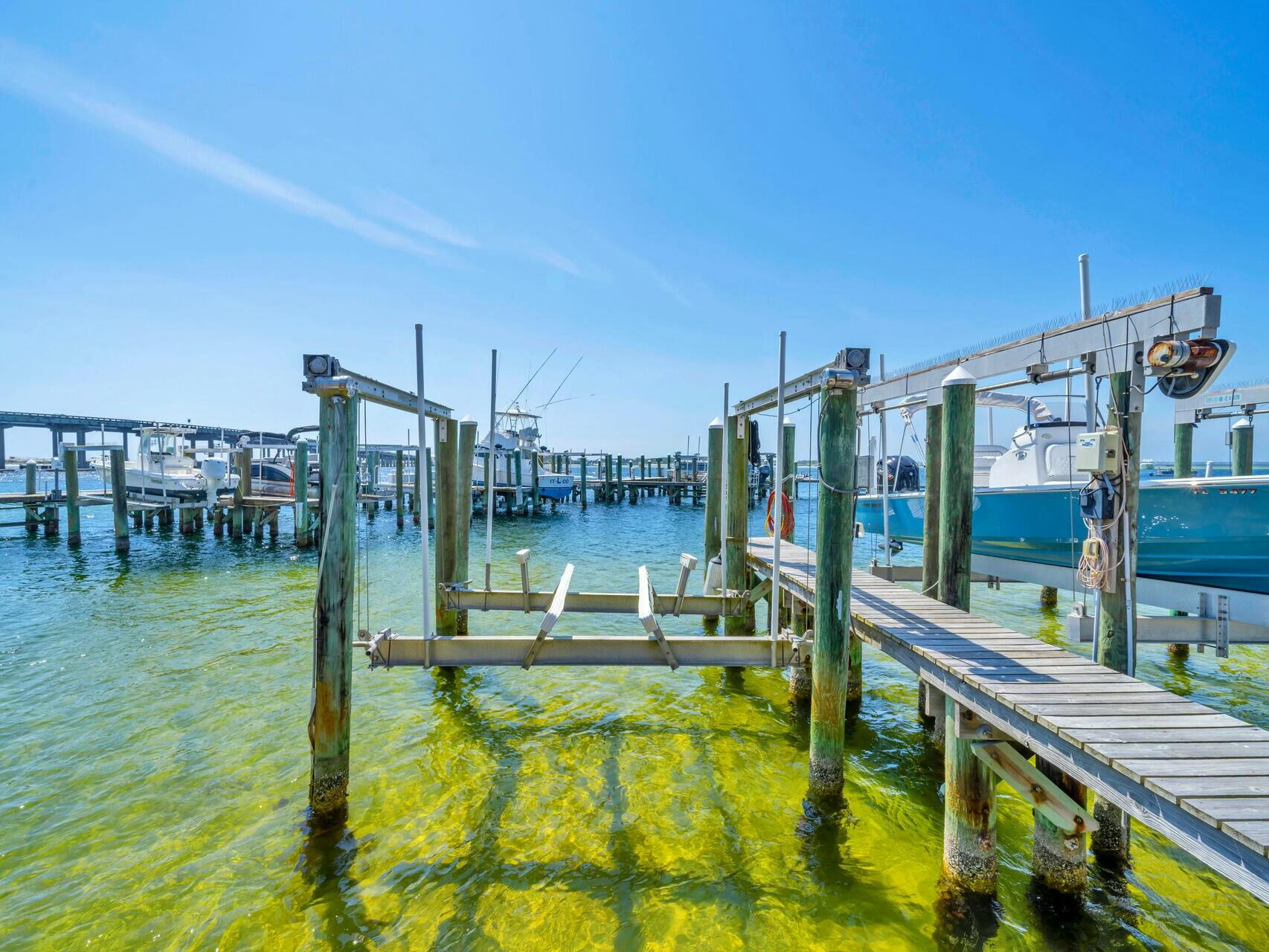 5 Calhoun Avenue, Unit 203 Destin, FL 32541 - Photo 45 of 67 a swimming pool with outdoor seating and yard