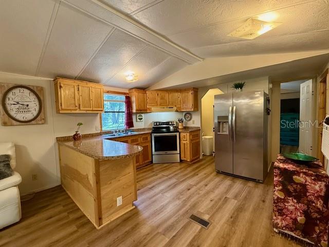 5043 Goodwin Road Brooksville, FL 34601 - Photo 11 of 47 a kitchen with stainless steel appliances granite countertop a refrigerator a stove and a sink