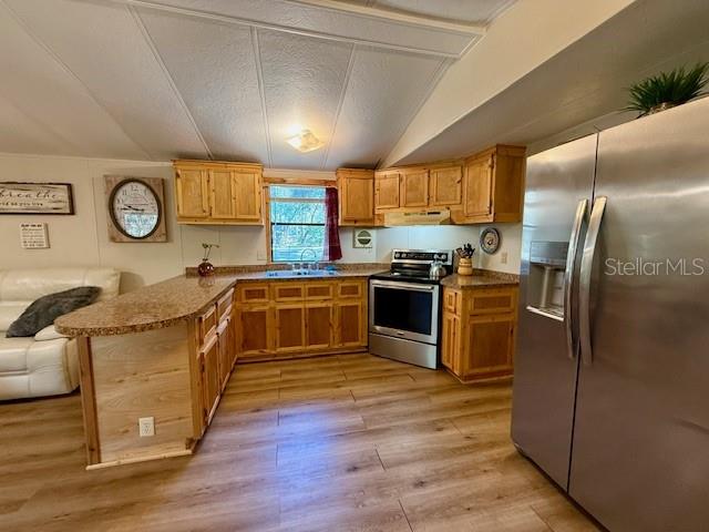5043 Goodwin Road Brooksville, FL 34601 - Photo 12 of 47 a kitchen with stainless steel appliances granite countertop a stove a sink and a refrigerator