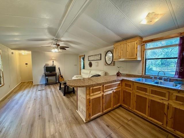 5043 Goodwin Road Brooksville, FL 34601 - Photo 13 of 47 a kitchen with a sink and wooden floor