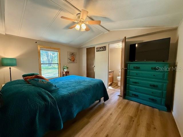 5043 Goodwin Road Brooksville, FL 34601 - Photo 16 of 47 a bedroom with a bed and a flat tv screen on dresser
