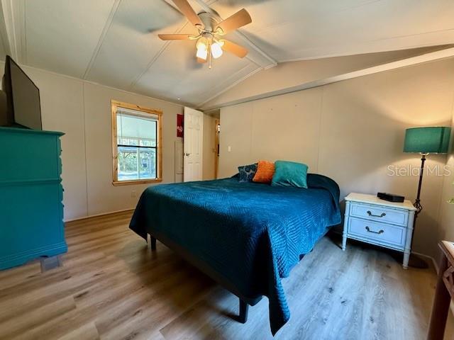 5043 Goodwin Road Brooksville, FL 34601 - Photo 17 of 47 a bedroom with a bed and a chandelier