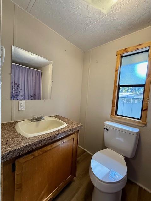 5043 Goodwin Road Brooksville, FL 34601 - Photo 19 of 47 a bathroom with a granite countertop toilet sink and mirror