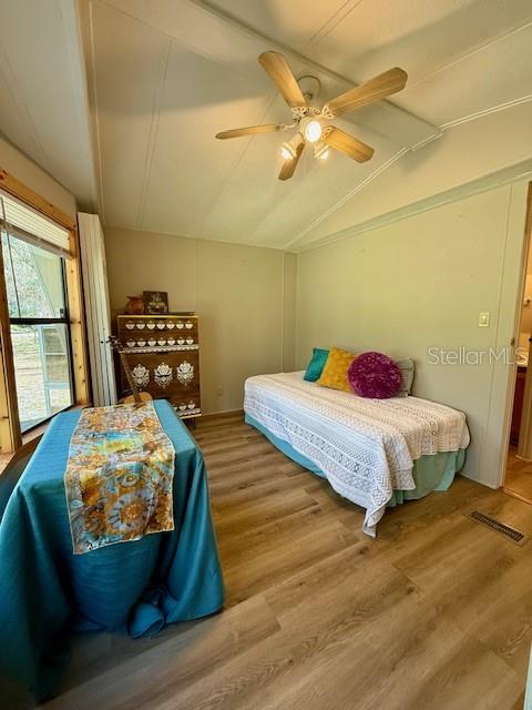 5043 Goodwin Road Brooksville, FL 34601 - Photo 21 of 47 a bedroom with a bed and wooden floor