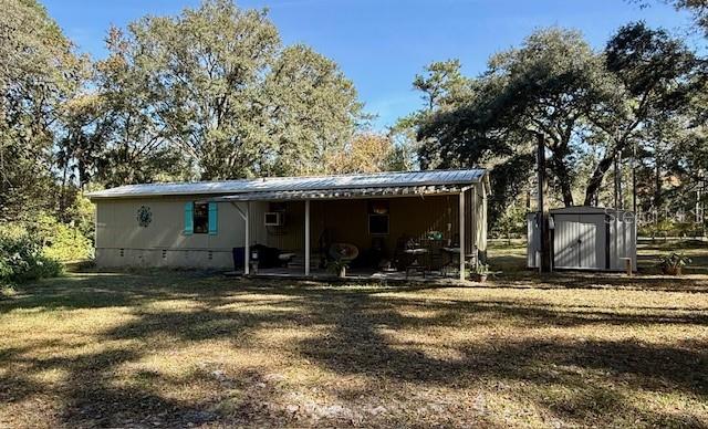 5043 Goodwin Road Brooksville, FL 34601 - Photo 26 of 47 a view of a house with yard and seating area