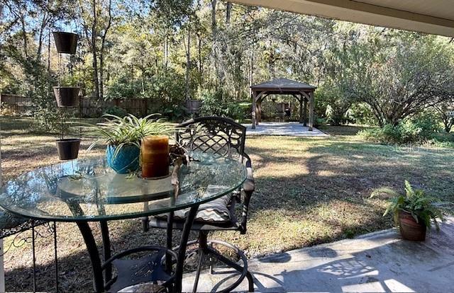 5043 Goodwin Road Brooksville, FL 34601 - Photo 27 of 47 a view of a house with backyard and sitting area
