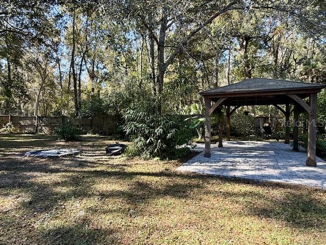 5043 Goodwin Road Brooksville, FL 34601 - Photo 28 of 47 a view of a barn with a table and chairs under an umbrella