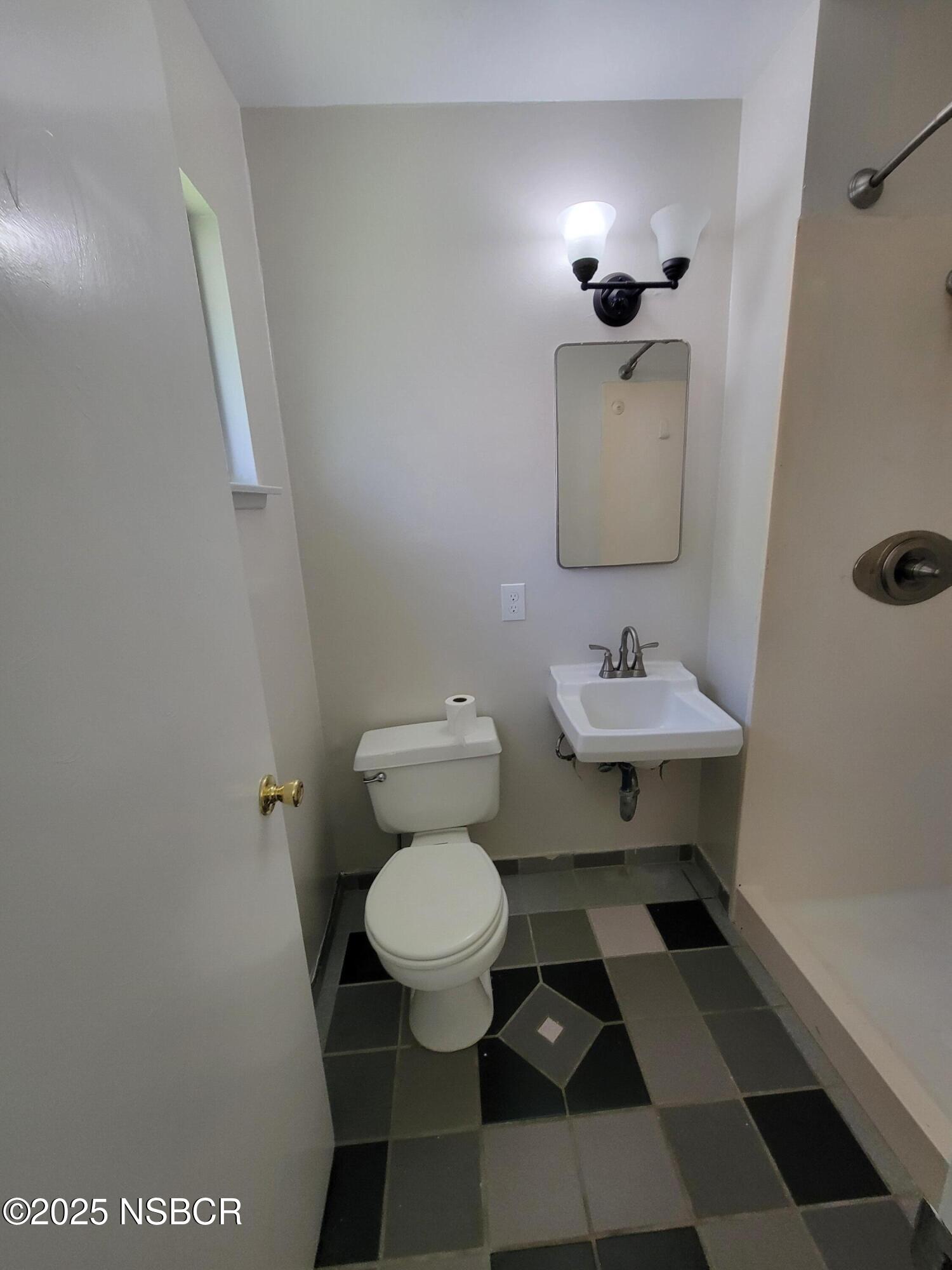 1328 West Willow Avenue Lompoc, CA 93436 - Photo 18 of 22 a bathroom with a sink toilet and a mirror