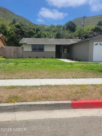 a front view of house with yard and outdoor seating
