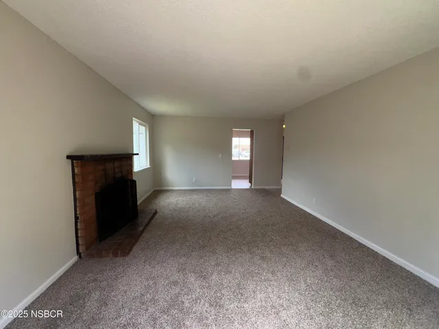 a view of empty room with a fireplace