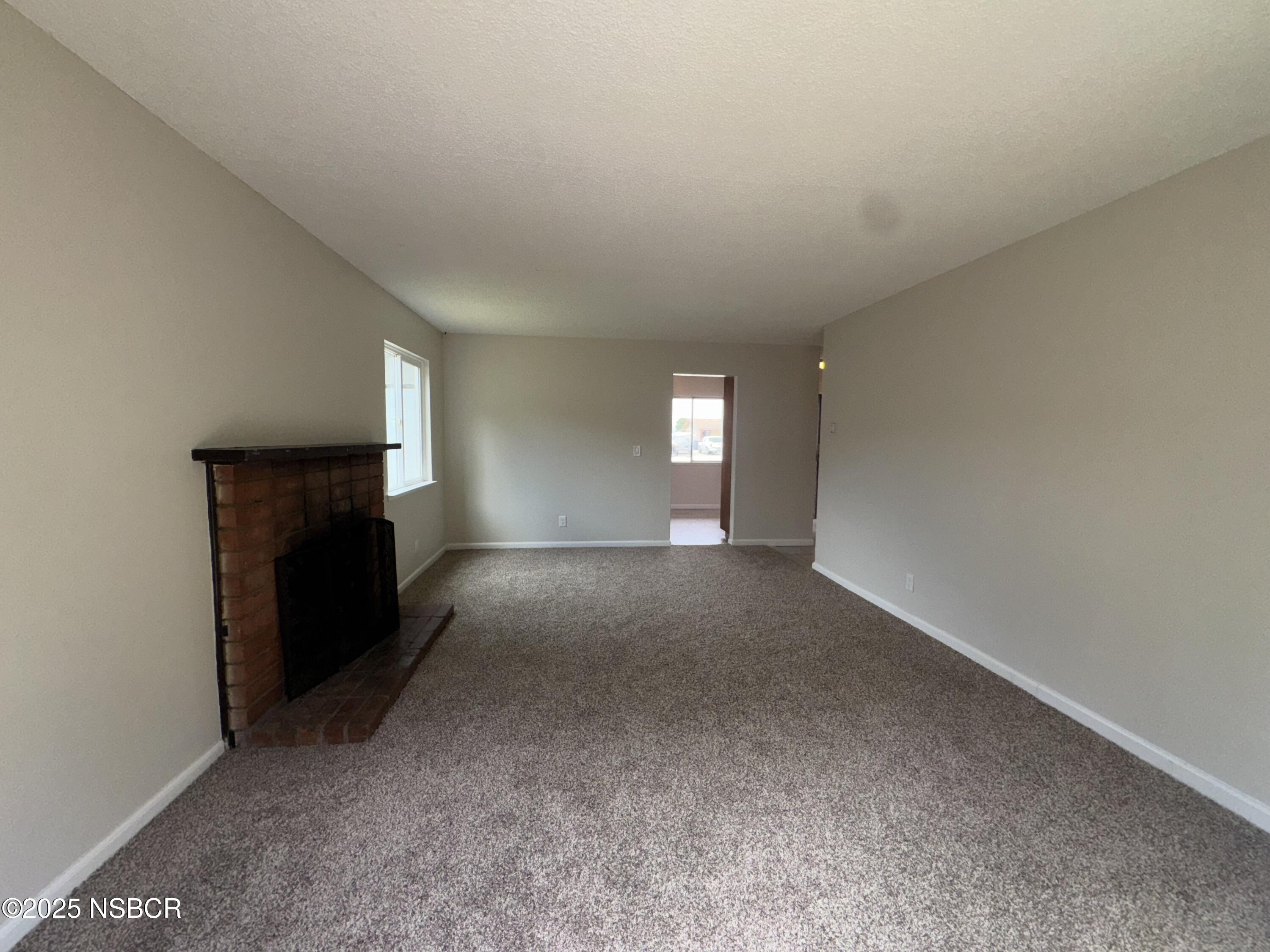 1328 West Willow Avenue Lompoc, CA 93436 - Photo 5 of 22 a view of empty room with a fireplace