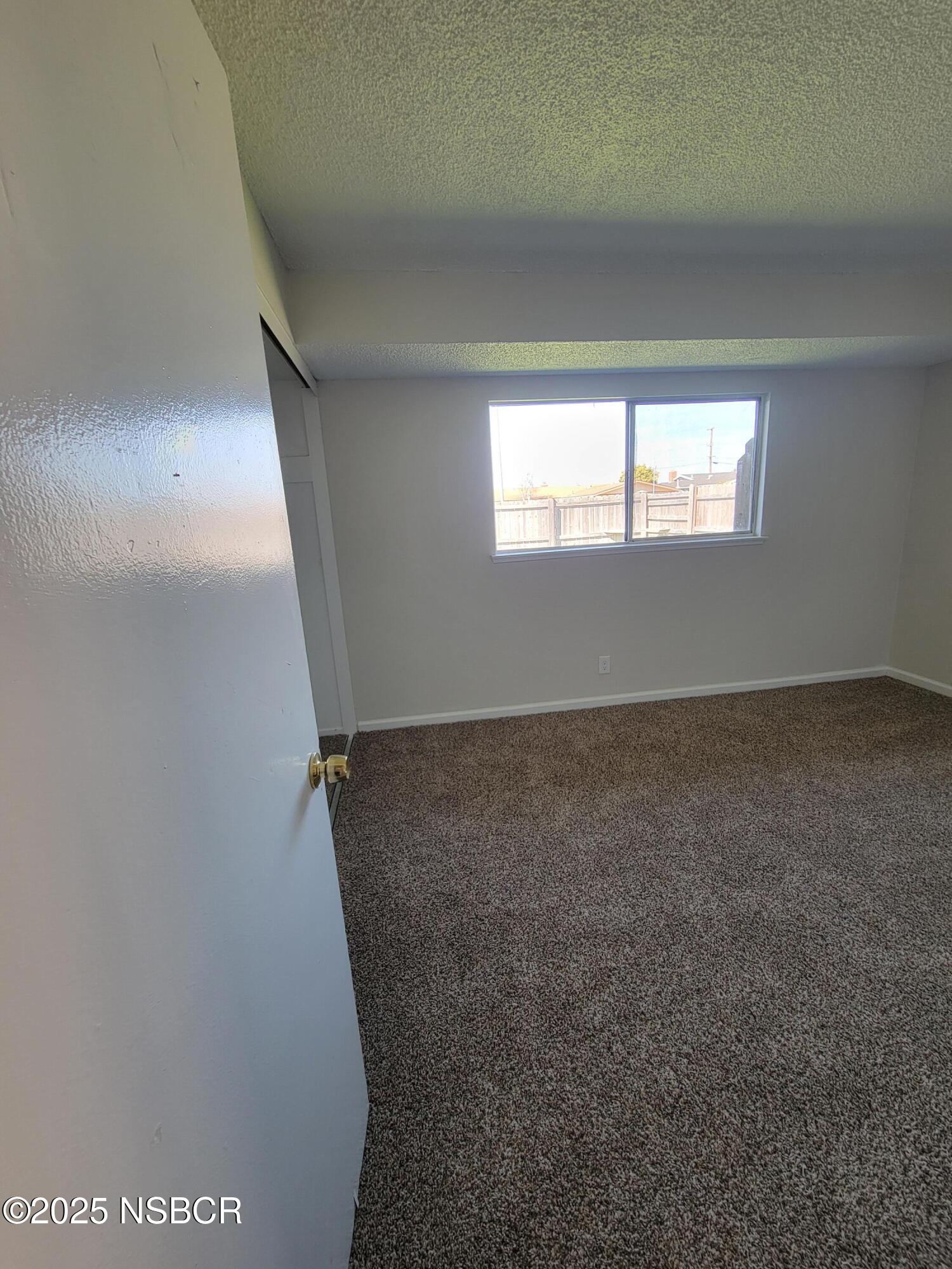1328 West Willow Avenue Lompoc, CA 93436 - Photo 7 of 22 an empty room with a window